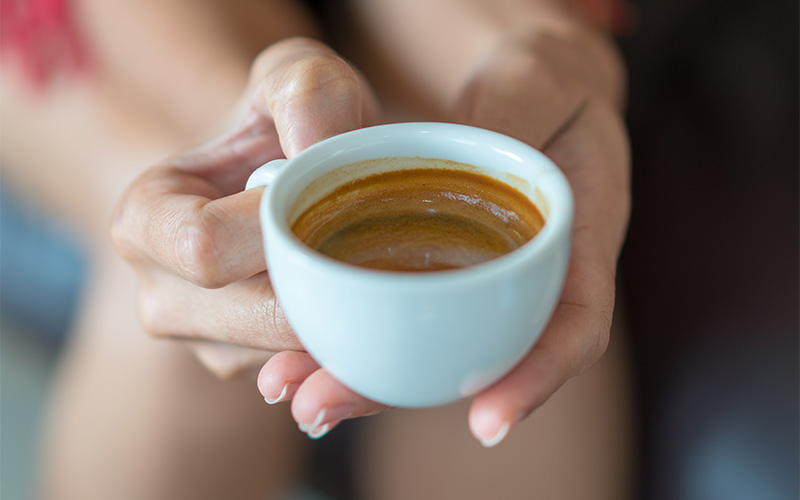 Lady's hands holding Coffee Cup